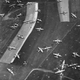 Taken on June 7, or D-Day plus one, British gliders, painted with black and white recognition stripes, lie strewn around Landing Zone N north of Ranville, Normandy. These gliders transported the 6th Airlanding Brigade and the Airborne Armoured Reconnaissance Regiment during Operation Mallard. (Imperial War Museum)